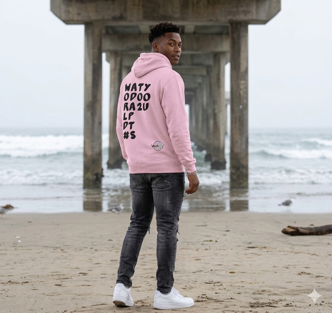 Back view of a person wearing a pink WATY message hoodie at the beach